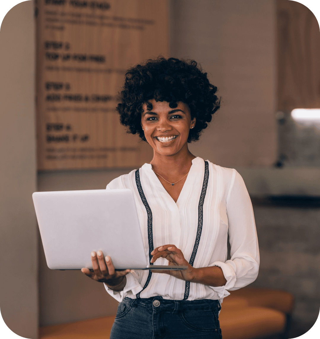 woman looking at a laptop and smiling